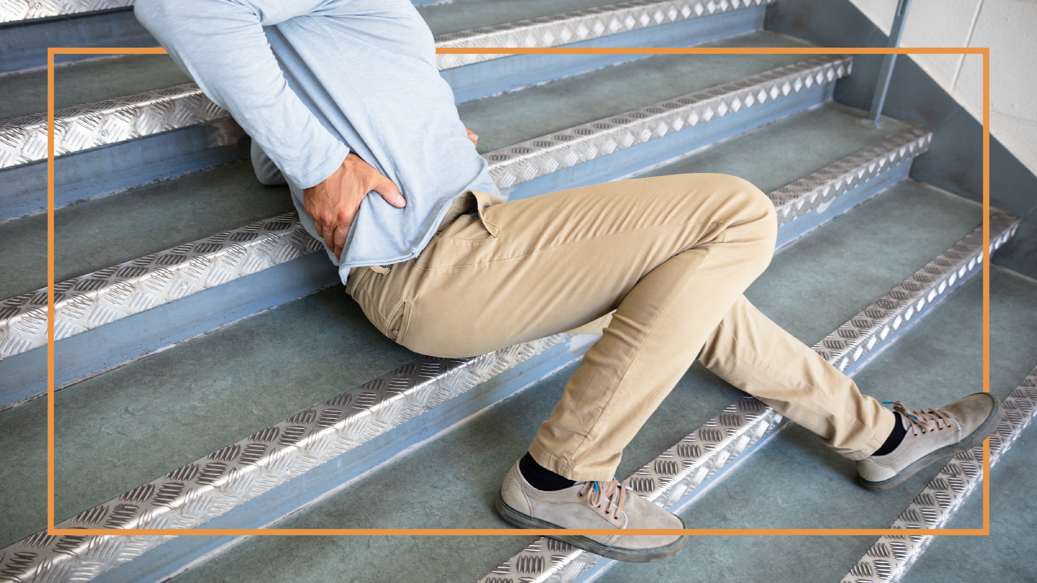 Slip and Fall Injury A person holding their back after slipping and falling on stairs