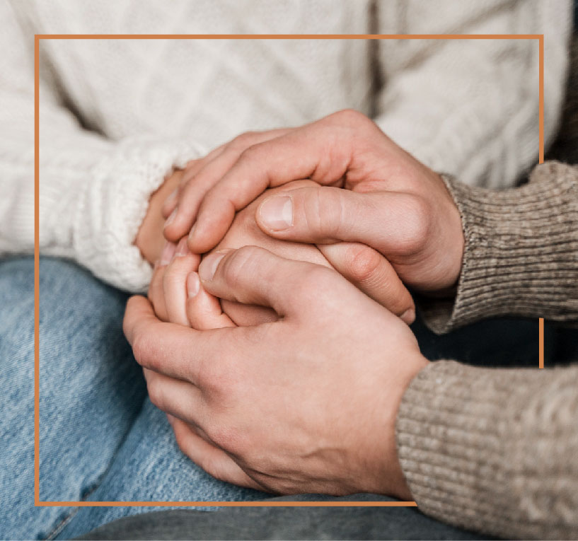 Support and Compassion After a Wrongful Death Two people holding hands in support after a wrongful death in the family