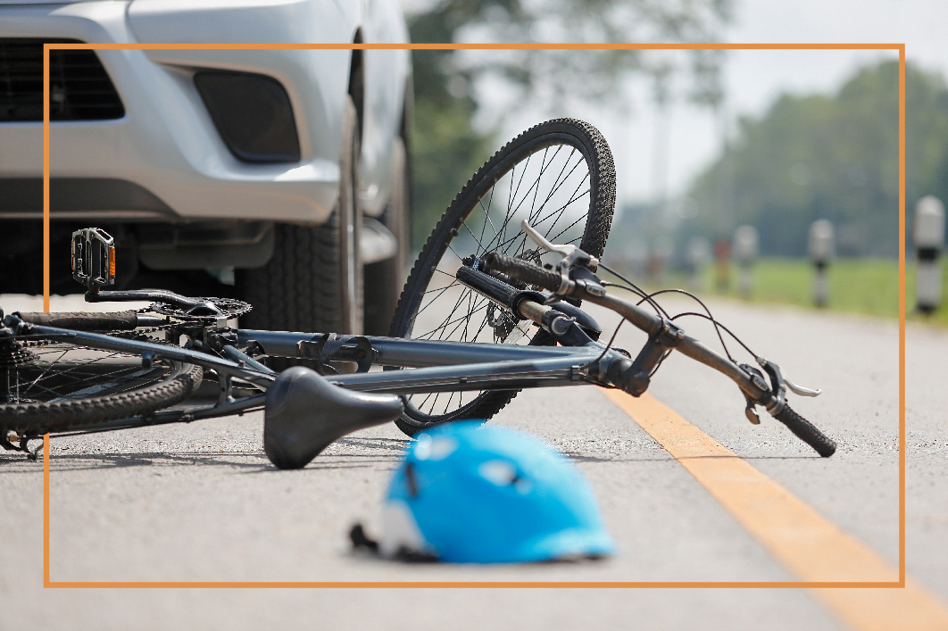 Bicycle accident involving a car at an intersection.